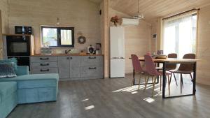 a kitchen with a table and chairs and a refrigerator at Olly House in Glebovka