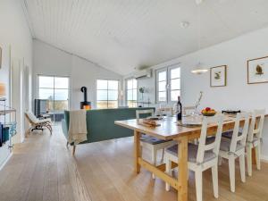 a kitchen and dining room with a table and chairs at Holiday Home Zaharinka - 300m from the sea by Interhome in Pandrup