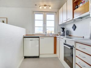 a kitchen with white appliances and a window at Holiday Home Zaharinka - 300m from the sea by Interhome in Pandrup