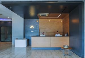 two men sitting at a counter in an office at Max Hotels Prayagraj in Allahābād