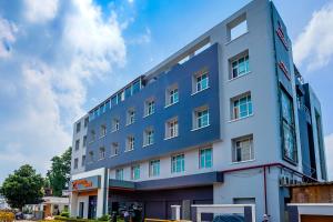 an office building with a blue building at Max Hotels Prayagraj in Allahābād