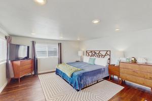 a bedroom with a bed and a dresser and a television at Hood Canal House in Shelton