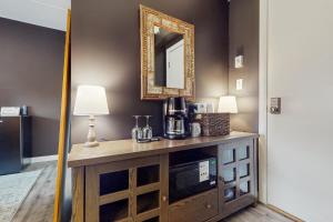 a room with a table with a microwave and a mirror at 5B Mountain Village- Unit B in Dover