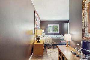 a bedroom with a bed and two lamps on a table at 5B Mountain Village- Unit B in Dover