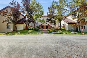 a large white house with a driveway at 5B Mountain Village- Unit B in Dover