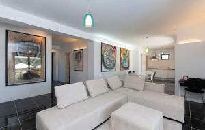 a living room with a white couch and a table at Villa Pucalo by Villas Guide in Kampor