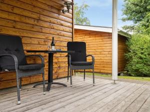 three chairs and a table on a deck at Holiday Home Krister - 250m to the inlet by Interhome in Farsø +21 photos