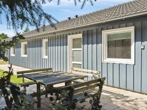 a picnic table in front of a house at Holiday Home Awenita - 50m to the inlet by Interhome in Løgsted