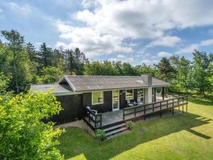 a house with a large deck in the yard at Holiday Home Angantir - 700m to the inlet by Interhome in Løgstør