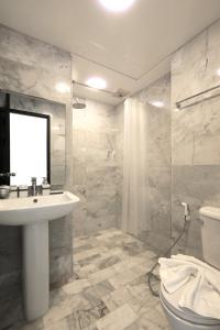 a bathroom with a sink and a shower and a toilet at 1bdr apartment NaiHarn Beach condo by Capital Pro in Phuket Town