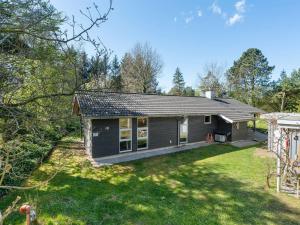 a small house in the middle of a yard at Holiday Home Marlien - 1km to the fjord by Interhome in Løgsted