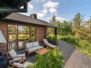 a patio with two chairs and a couch at Holiday Home Andri - 600m to the fjord by Interhome in Løgstør +18 photos