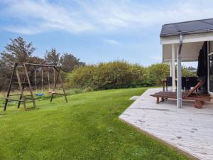 un cortile con parco giochi e altalena di Holiday Home Herbiorn - 403m from the sea by Interhome a Hjørring