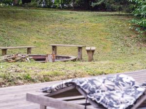 a wooden bench sitting on top of a field at Holiday Home Karitte - 5km from the sea by Interhome in Fjerritslev