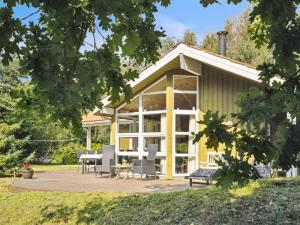 a house with a large screened in porch at Holiday Home Karitte - 5km from the sea by Interhome in Fjerritslev