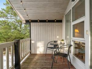 a screened porch with a table and chairs on it at Holiday Home Freda - 100m to the inlet by Interhome in Løgsted