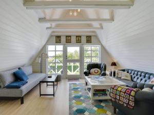 a living room with a couch and a table at Holiday Home Tamer - 500m to the fjord by Interhome in Farsø