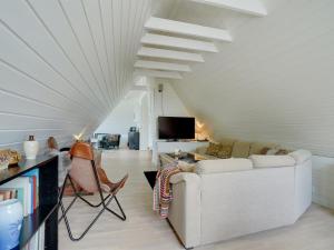 a living room with a white ceiling and a couch at Holiday Home Tamer - 500m to the fjord by Interhome in Farsø