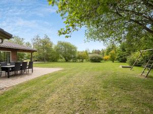 a patio with a table and chairs in a yard at Holiday Home Els - 900m from the sea by Interhome in Fjerritslev