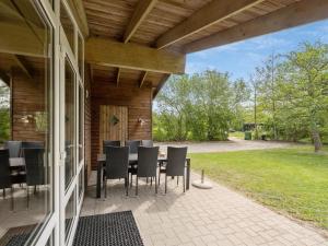a patio with a table and chairs on a house at Holiday Home Els - 900m from the sea by Interhome in Fjerritslev +15 photos