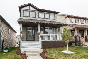 a house with a front porch and a house at Chic 6BDRM Getaway - KingBed - Patio - BBQ - Garage - Wifi in Edmonton