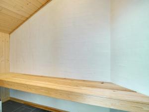 a wooden bench in the corner of a room at Holiday Home Aria - 1-2km from the sea by Interhome in Hirtshals