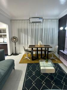 a living room with a table and some chairs at Royal tamah concept in Ikate
