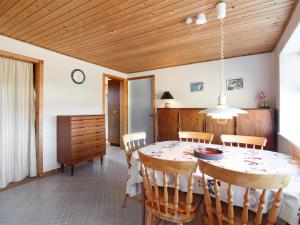 a kitchen and dining room with a table and chairs at Holiday Home Nea - 234m from the sea by Interhome in Hirtshals
