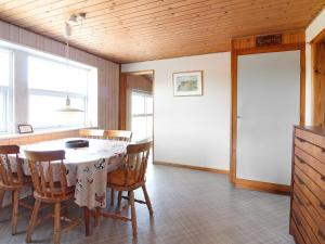 a dining room with a table and chairs at Holiday Home Nea - 234m from the sea by Interhome in Hirtshals