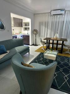 a living room with a couch and a table at Royal tamah concept in Ikate +10 photos
