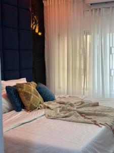 a bed with pillows and a blanket on it at Royal tamah concept in Ikate