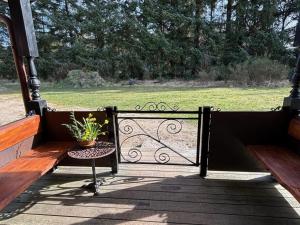 a porch with a bench and a gate with a potted plant at Holiday Home Marla - 1-1km from the sea by Interhome in Bindslev +30 photos