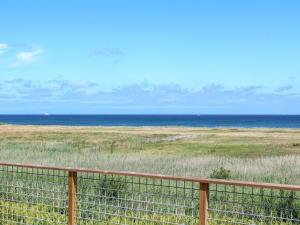 a view of the ocean from a fence at Holiday Home Marlena - 150m from the sea by Interhome in Frederikshavn