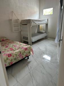a bedroom with two bunk beds and a tiled floor at Casa na Ilha de Itamaraca in Vila Velha +25 photos
