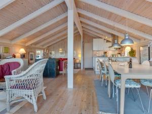 a kitchen and dining room with a table and chairs at Holiday Home Bille - 200m from the sea by Interhome in Læsø