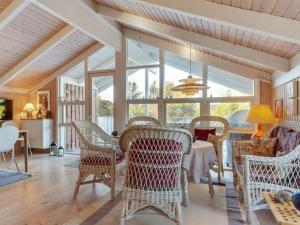 a living room with wicker chairs and a table at Holiday Home Bille - 200m from the sea by Interhome in Læsø +18 photos