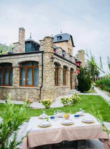 a table in front of a large stone house at El Torreón de Cepones in Segovia +24 photos