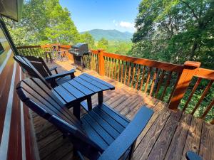 two chairs and a table on a deck with a grill at Mount Jefferson Vistas in West Jefferson