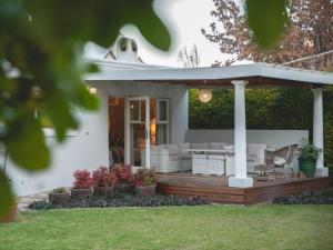 a house with a deck with a gazebo at Connie’s Cottages in Montagu