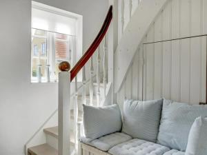 a white staircase with a couch in a room at Holiday Home Stephie - 1-1km from the sea by Interhome in Skagen