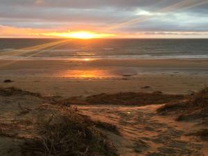 a sunset on a beach with the ocean at Holiday Home Gerulf - 600m from the sea by Interhome in Skagen