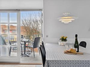 a dining room with a table and a balcony at Apartment Ayna - 150m from the sea by Interhome in Skagen