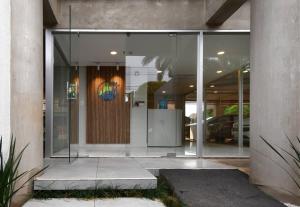 a glass door of a building with a sign on it at Carlos Estupendo departamento nuevo y confortable 106 in Fernando de la Mora