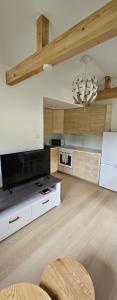 a living room with a large television and a chandelier at TitiBlu2040 in Klofta
