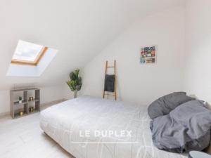 Ένα ή περισσότερα κρεβάτια σε δωμάτιο στο Cosy Urbain - 5 appartements à Montluçon