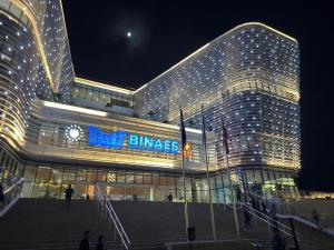 un gran edificio con un reloj en él por la noche en Zona Rosa San Benito 1 cuartito, en San Salvador