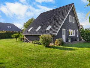 a gray house with a gambrel roof at Holiday Home Begitte - 200m from the sea by Interhome in Hesselager