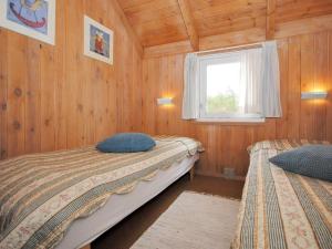 a bedroom with two beds and a window at Holiday Home Fredsine - 900m from the sea by Interhome in Fjerritslev +16 photos