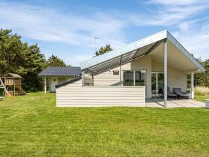 a modern house with a glass roof at Holiday Home Thove - 600m from the sea by Interhome in Blåvand