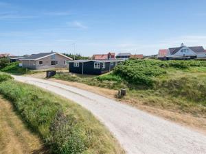 a dirt road in front of houses on a hill at Holiday Home Anik - 100m from the sea by Interhome in Torsted
